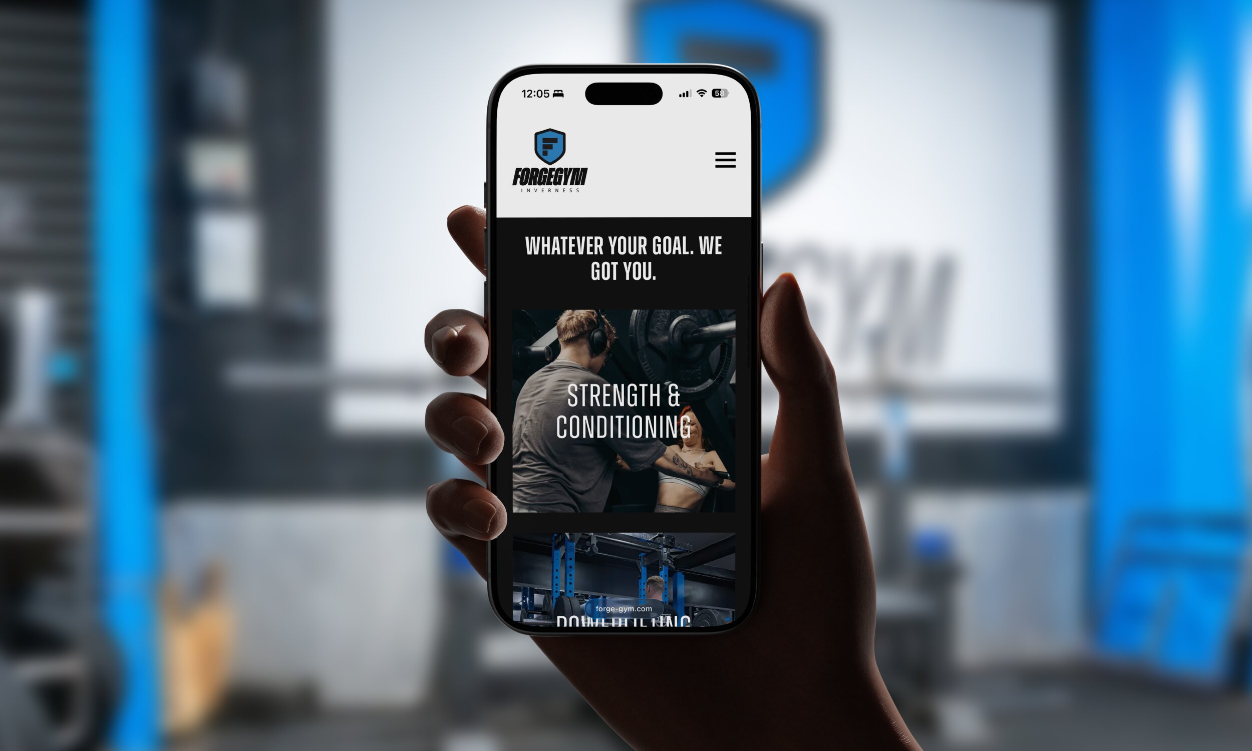 Hand holding smartphone displaying Forge Gym Inverness mobile website homepage with strength and conditioning imagery