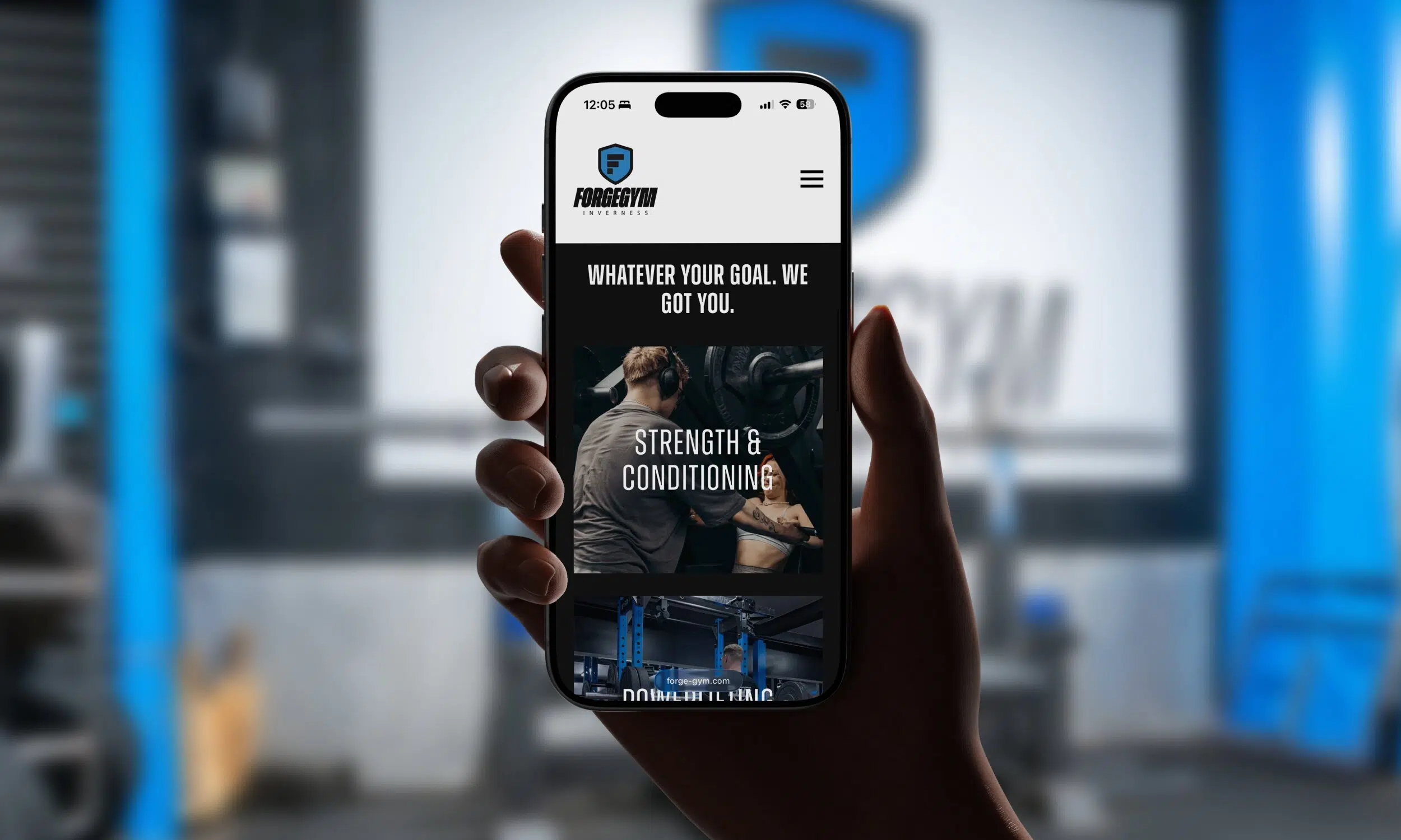 Hand holding smartphone displaying Forge Gym Inverness mobile website homepage with strength and conditioning imagery