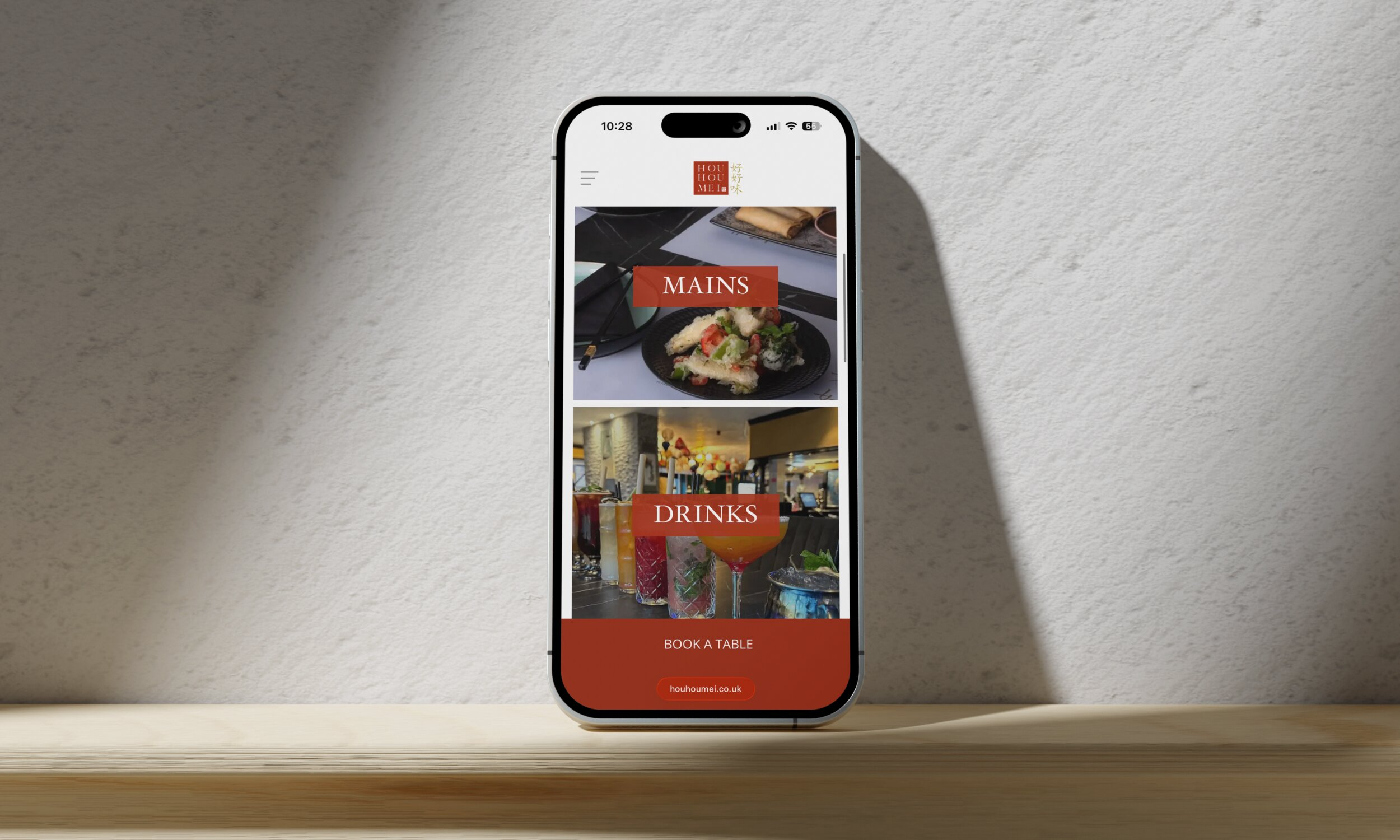 Smartphone displaying Hou Hou Mei restaurant mobile website with menu sections and table booking button