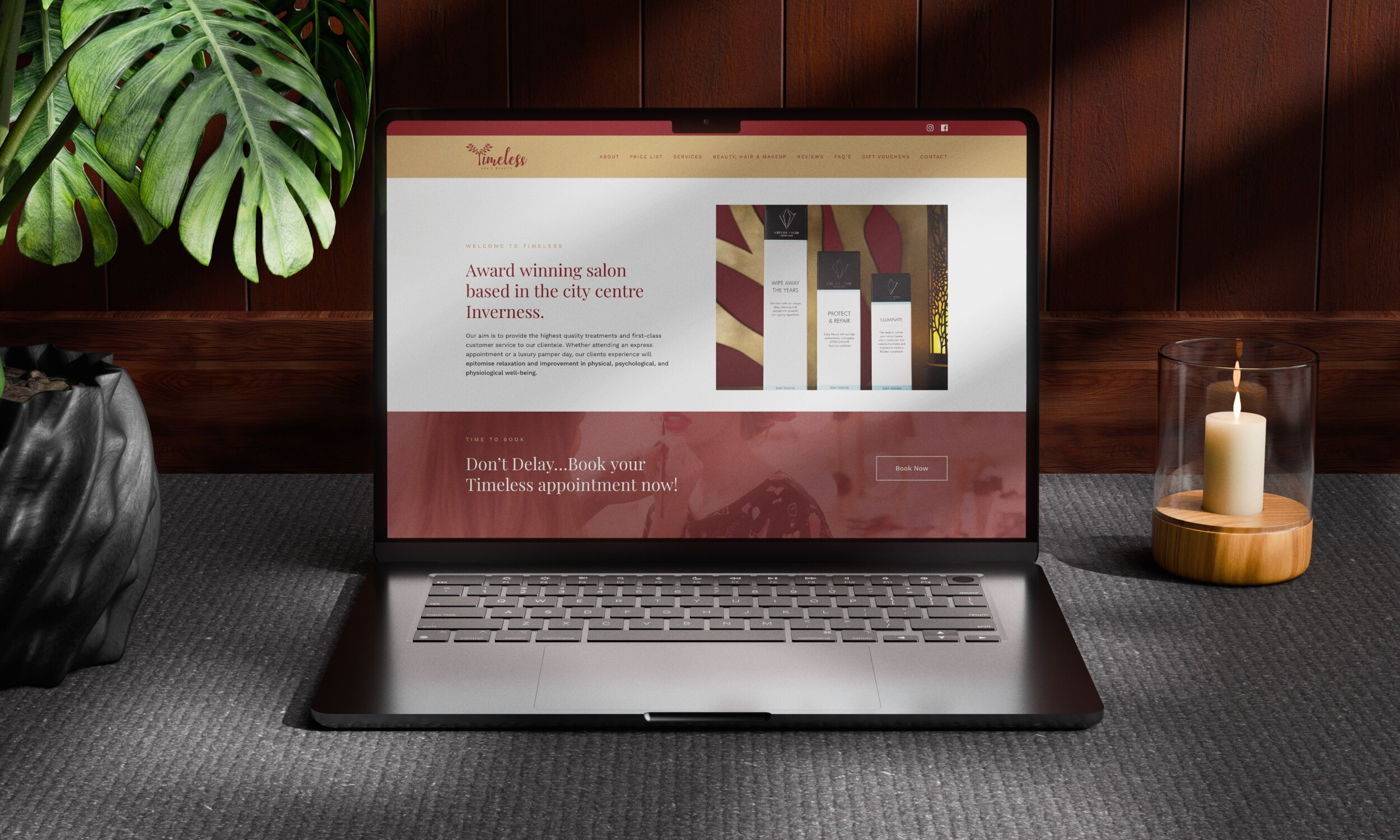 Laptop displaying Timeless Salon website homepage with burgundy and cream colour scheme in styled workspace setting